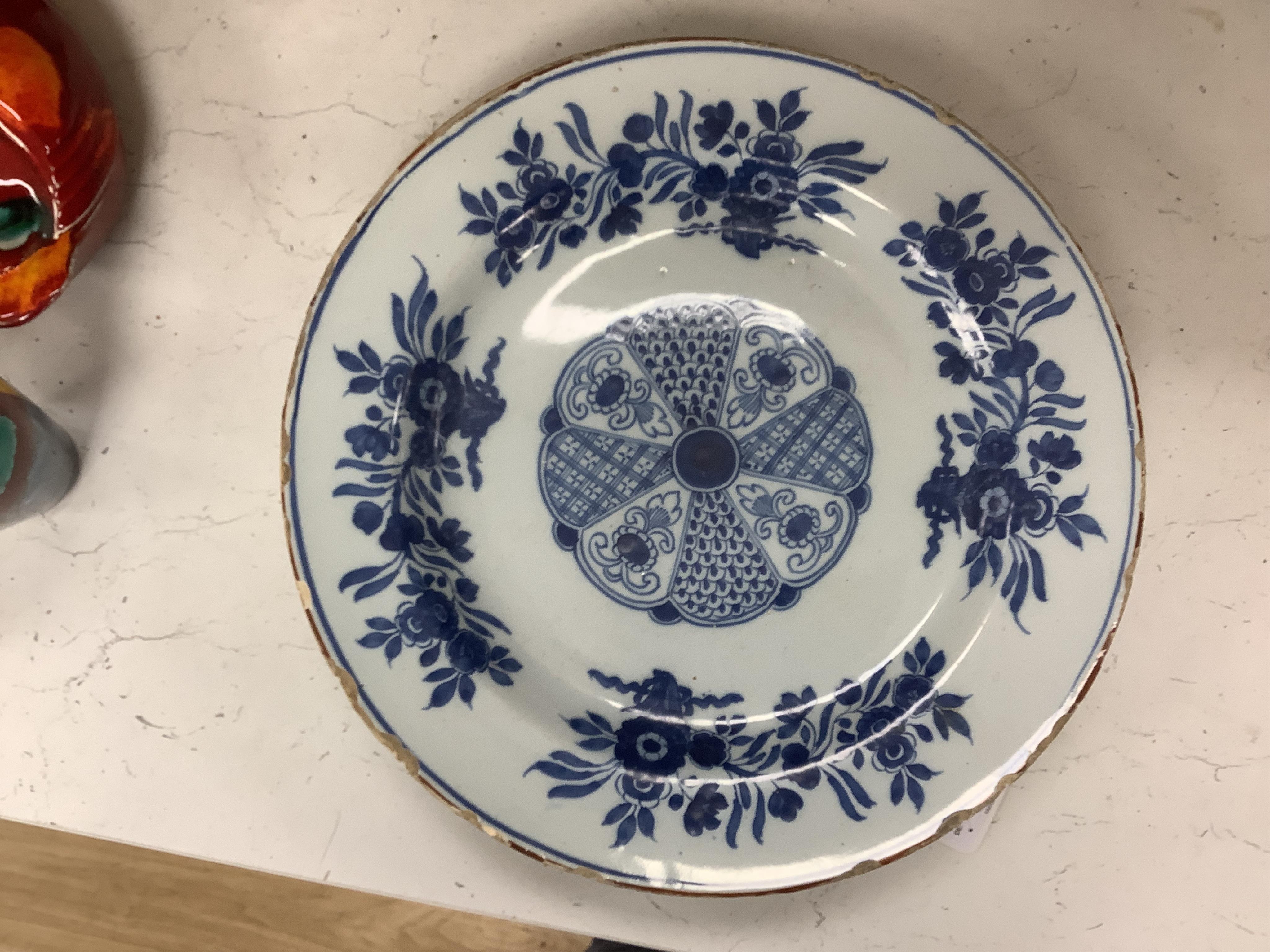 Five 18th century Delft dishes, largest 36.5cm diameter. Condition - poor to fair